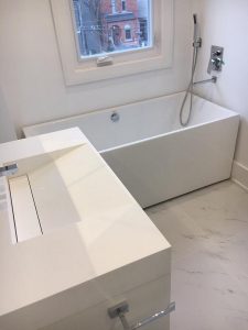 Toronto bathroom renovation Project by milman features white tiles, bathtub and vanity
