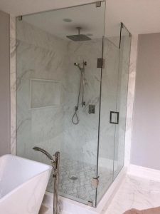 Toronto bathroom renovation Project by milman features white tiles and walk in shower with bathtub