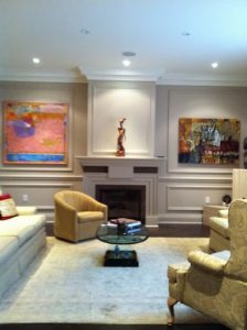 Milman Design Build presents a Toronto basement renovation that showcases bespoke carpentry, an accent wall, a fireplace, and indoor lighting.
