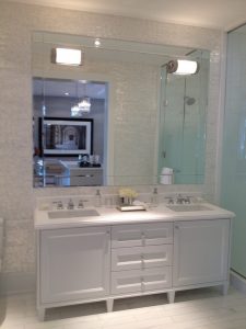 Toronto bathroom renovation project features modern white bathroom with double vanity
