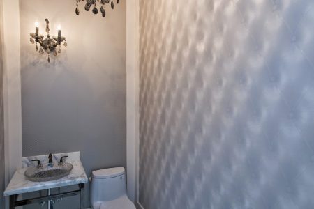 bathroom renovation with wall accents and custom vanity