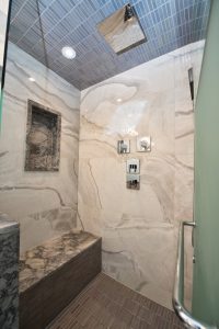 bathroom renovation featuring glass shower enclosure and tiles