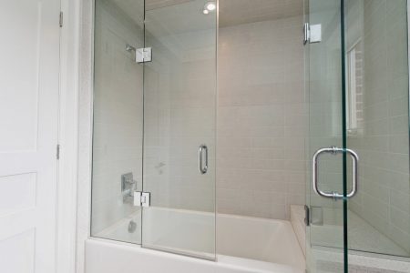 Toronto bathroom renovated with Glass Pivot Shield Shower Doors And Enclosures
