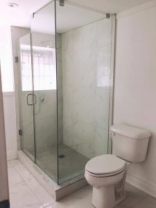 Toronto Bathroom renovation by Milman Design build features white tiles, glass bathroom enclosure