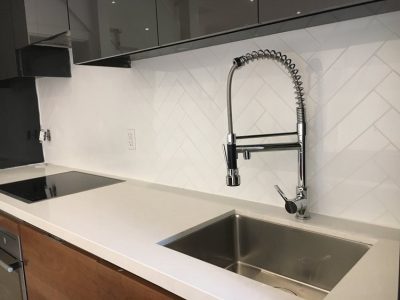Toronto kitchen renovation featuring quartz counter top , sink , faucet and backsplash installation