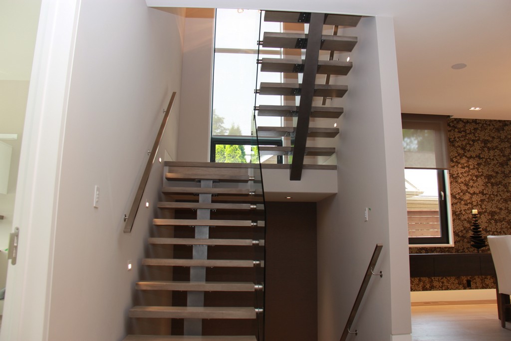 Home renovation project by Milman Design Build, Toronto Home Renovation contractors featuring staircase with glass railings