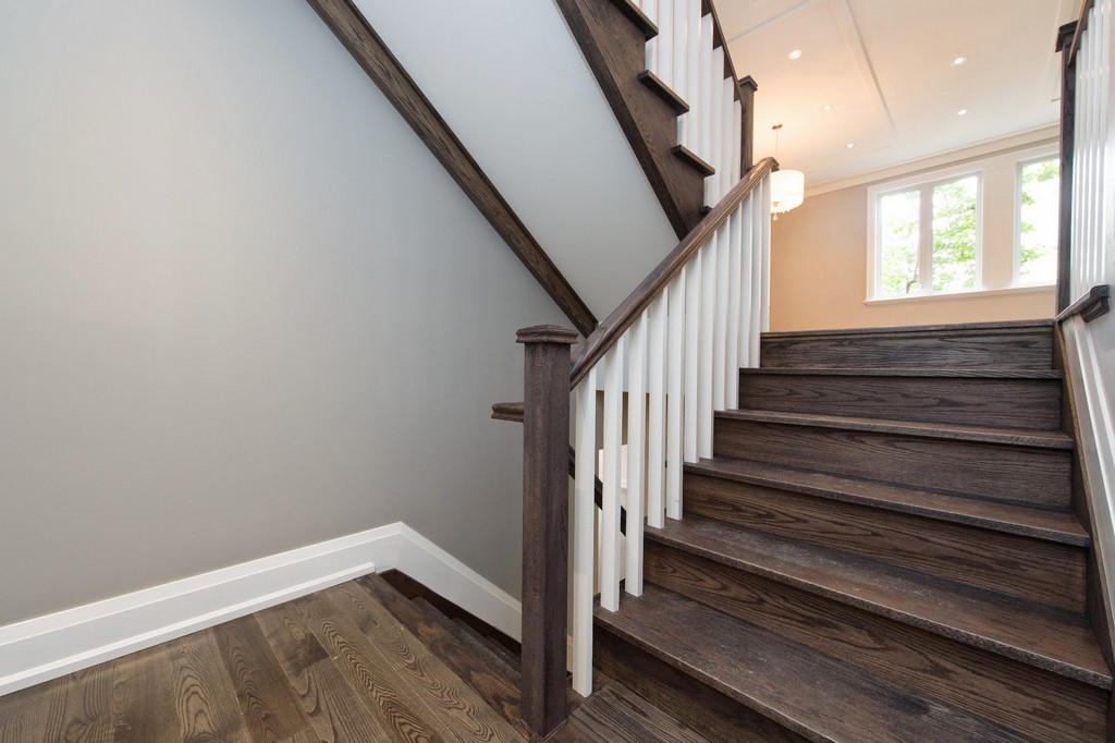 Home renovation project by Milman Design Build, Toronto Home Renovation contractors featuring custom staircase in oak wood, celling trims and potlights