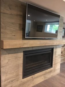Milman Design Build carried out renovations on an Aurora home, including the addition of a television, a fireplace, and improvements to the side wall and flooring