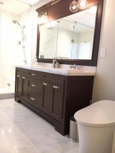 Milman Design Build carried out renovations on an Aurora home, adding two sinks, a large mirror, a bathing area, and cabinets.