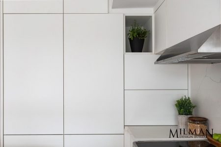 Toronto kitchen renovation project by Milman Showcasing white glossy cupboards..