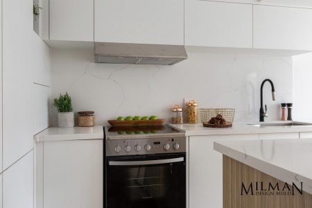 Toronto Kitchen renovations by Milman Design build featuring Glossy White Cabinets and Black Faucet